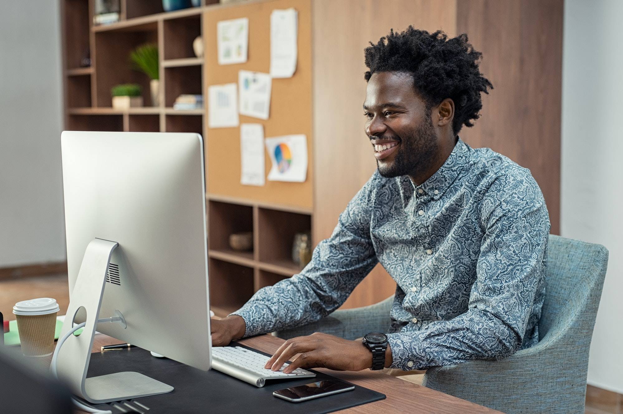 happy-african-businessman-using-computer.jpg